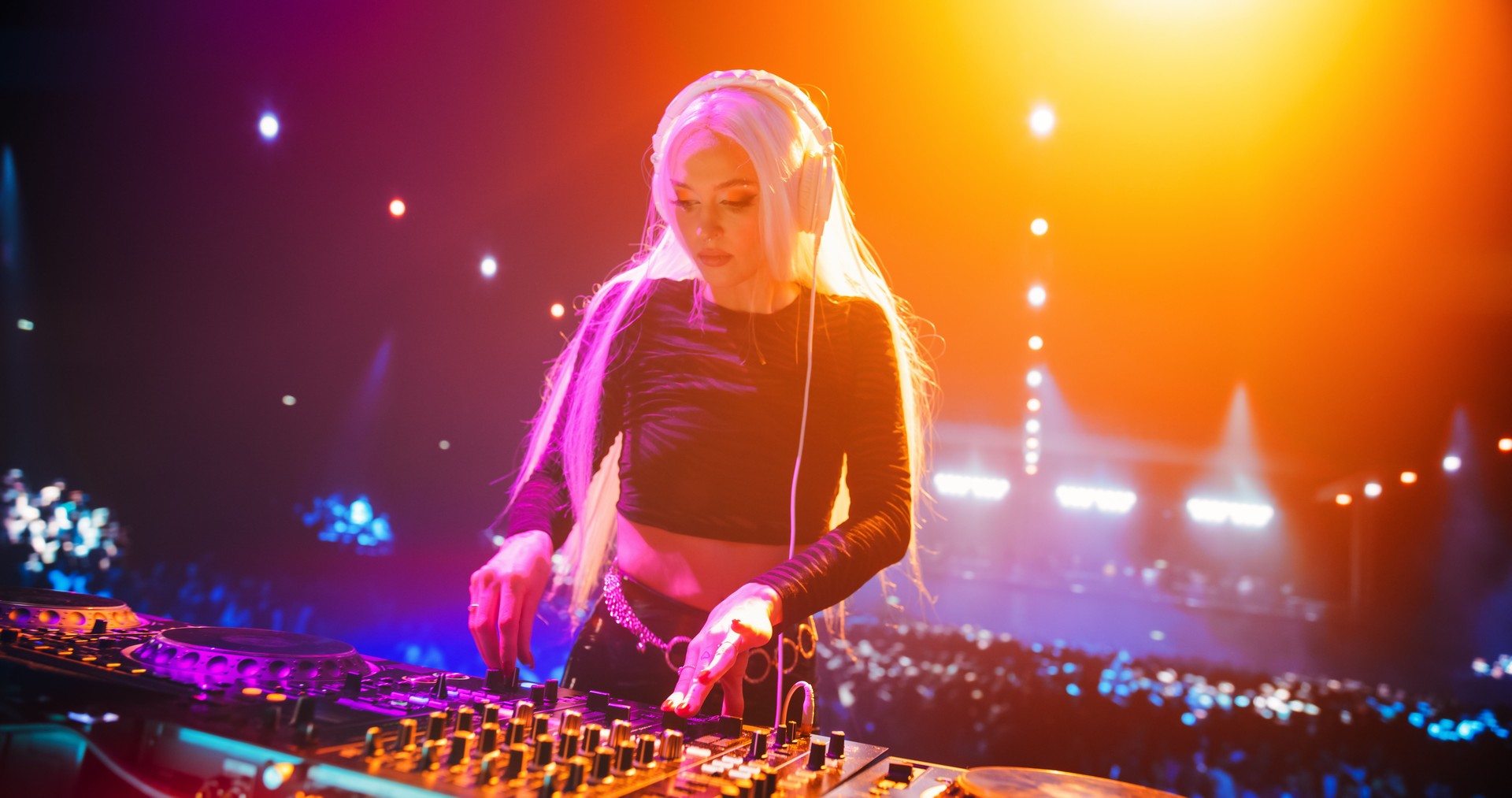 Beautiful Female DJ Playing Dance Music Sets, EDM, Techno, House Tracks at a Nightclub with Energetic Fans. Music Artist Celebrating a Successful Performance Under Neon Lights and Falling Confetti